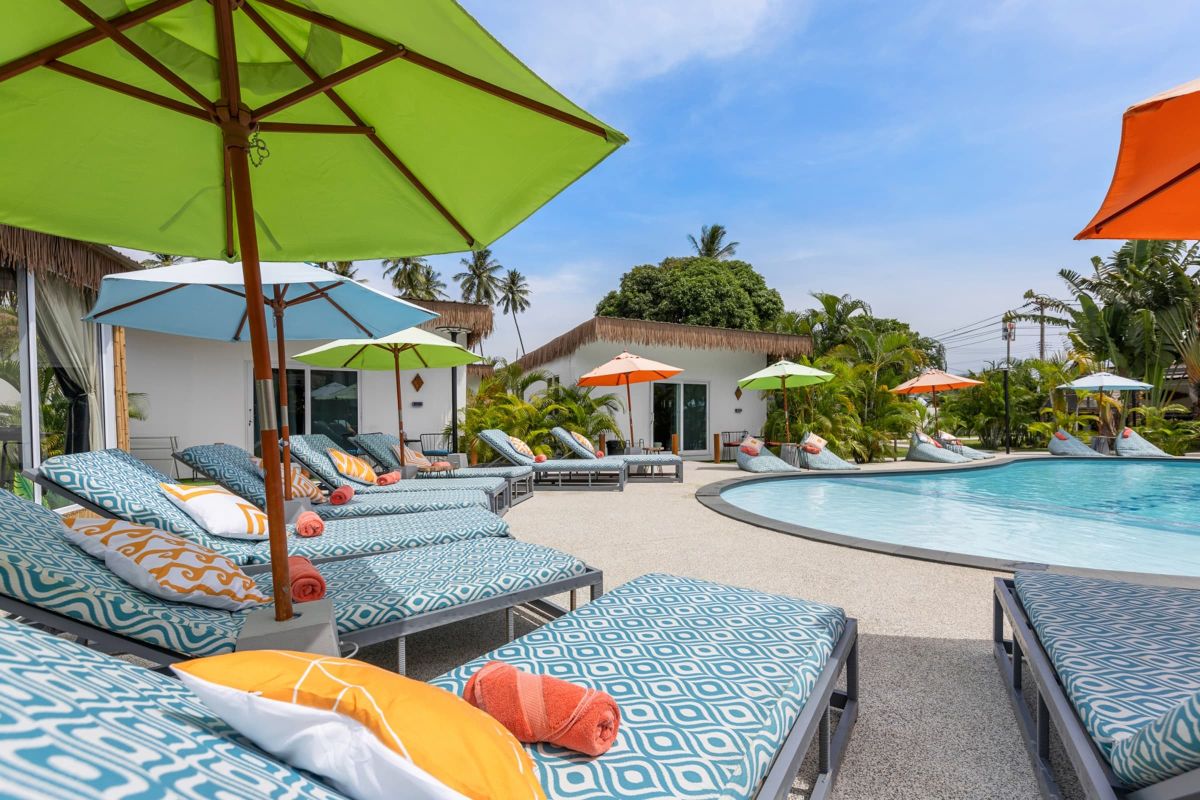 Maya resort welcome image with pool and sun-beds