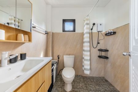 Garden Villa bathroom with a walk-in shower, washbasin and hairdryer.