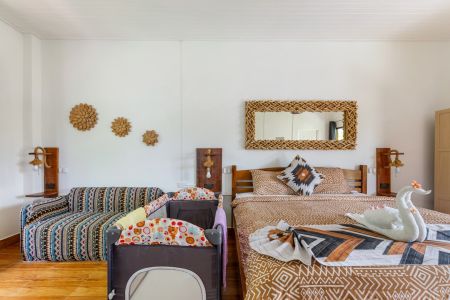 Garden Villa set up for a family, with a double bed, extra single bed and a baby cot.